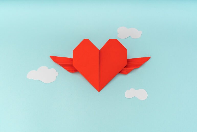 vector-heart-flying-in-clouds