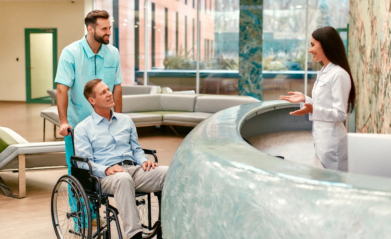 patient-in-wheelchair-talking-to-receptionist