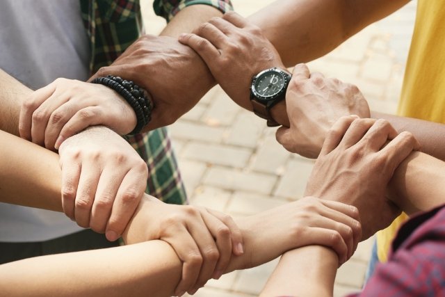 different-people-holding-hands-together