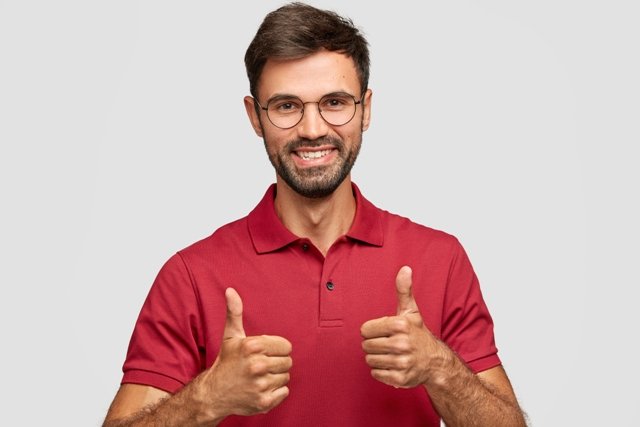 photo-attractive-bearded-young-man-with-cheerful-expression-makes-okay-gesture-with-both-hands